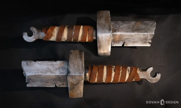 Pair of prop straight sword hilt cosplay props, based on Dark Souls. Photo taken from above on a black background.