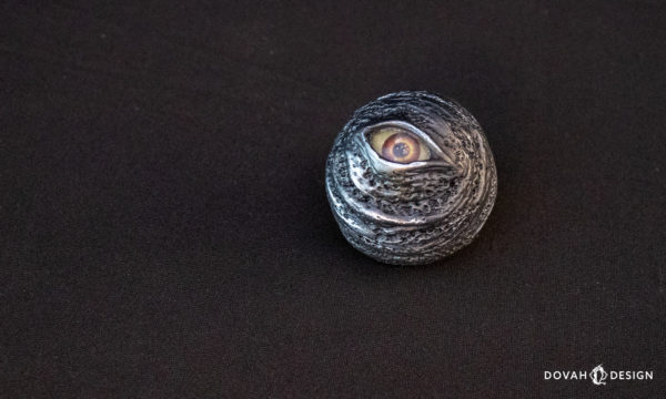 Single Dark Souls "Black Eye Orb" prop replica, sitting on a black background, the eye looking in to the camera.