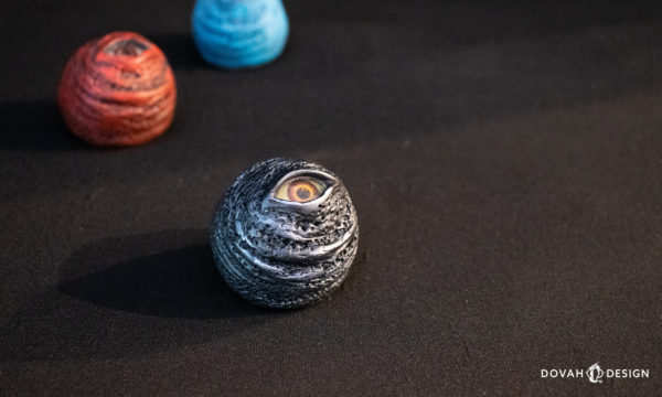 Blue, Red, and Black "Eye Orb" props, sitting on a black background.