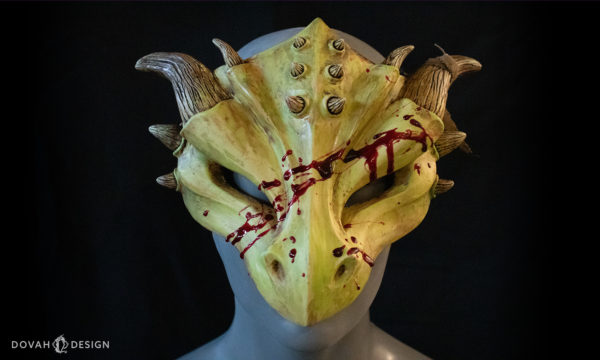 "Zombie" style dragon masquerade mask, facing forward on black background.