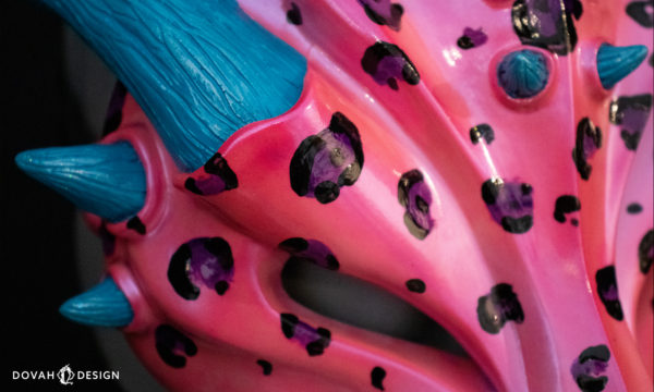 Hot pink leopard "Lisa Frank" inspired dragon mask, close up detail of hand painted spots.